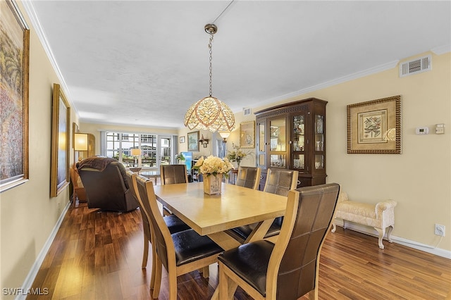 dining room featuring crown molding and hardwood / wood-style floors