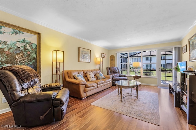 living room with ornamental molding and hardwood / wood-style flooring