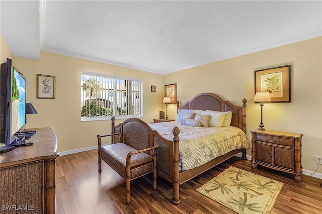 bedroom with hardwood / wood-style flooring and ornamental molding