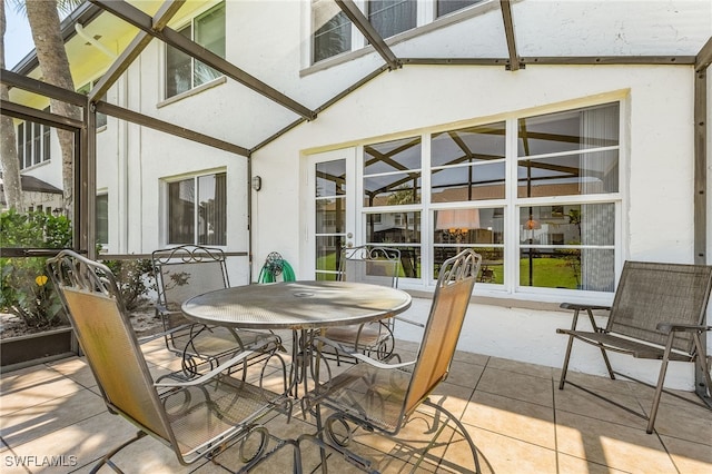 sunroom / solarium featuring lofted ceiling