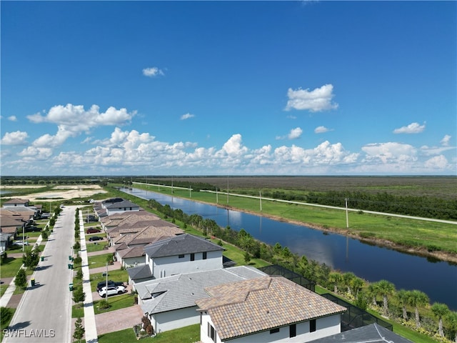 drone / aerial view featuring a water view and a rural view