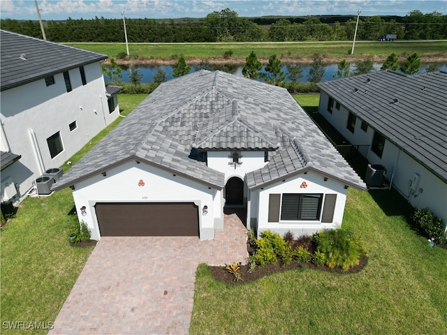 view of front of property with a front yard and a water view