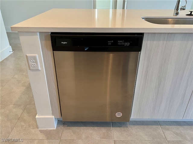 room details featuring dishwasher, light tile patterned flooring, and sink