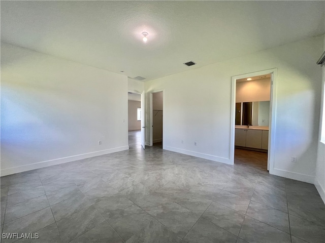 spare room featuring a textured ceiling