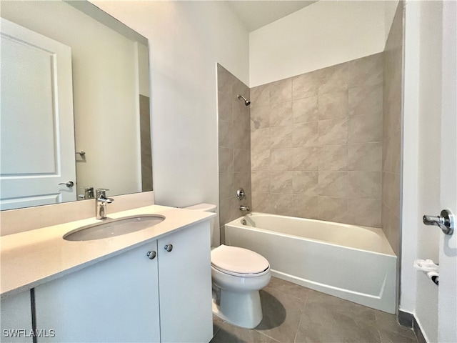 full bathroom featuring tiled shower / bath combo, vanity, toilet, and tile patterned floors