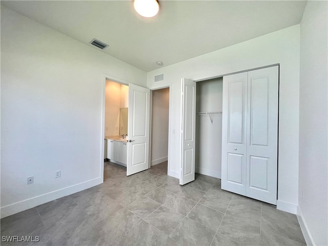 unfurnished bedroom featuring light tile patterned floors and a closet