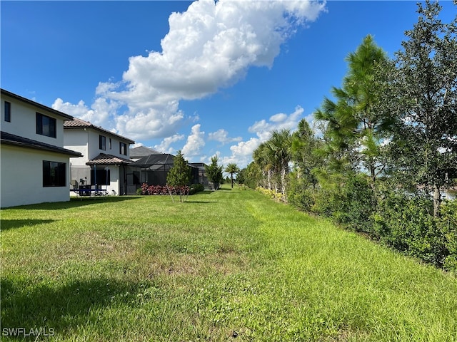 view of yard featuring a lanai