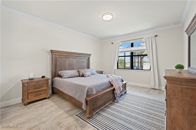 bedroom featuring crown molding and light hardwood / wood-style flooring