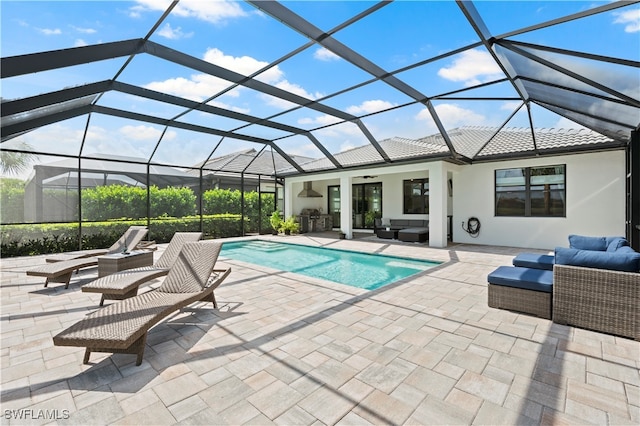 view of pool with an outdoor living space, a lanai, and a patio