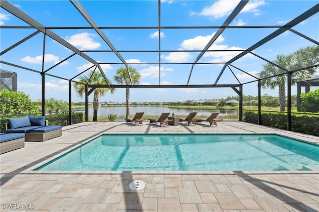 view of pool featuring glass enclosure, a water view, and a patio