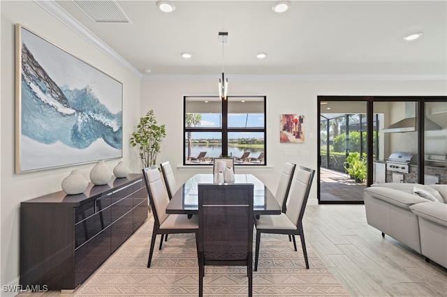 dining area featuring light wood-type flooring and ornamental molding