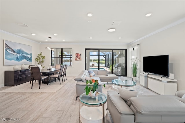 living room with ornamental molding and light hardwood / wood-style flooring