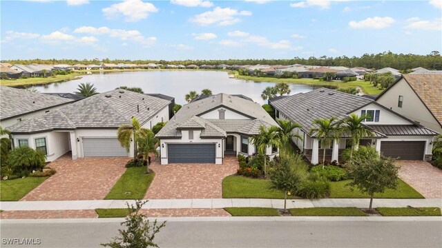 view of front of house with a garage and a water view