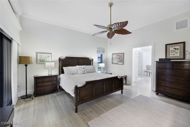 bedroom featuring connected bathroom, visible vents, a ceiling fan, ornamental molding, and light wood-type flooring