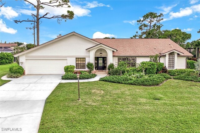 ranch-style home featuring a garage and a front lawn