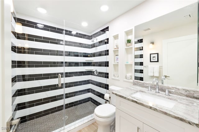 bathroom with toilet, a stall shower, recessed lighting, and vanity