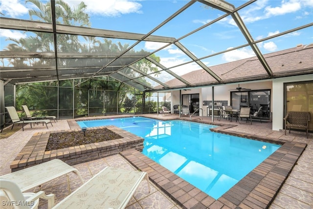 pool with a lanai, ceiling fan, and a patio