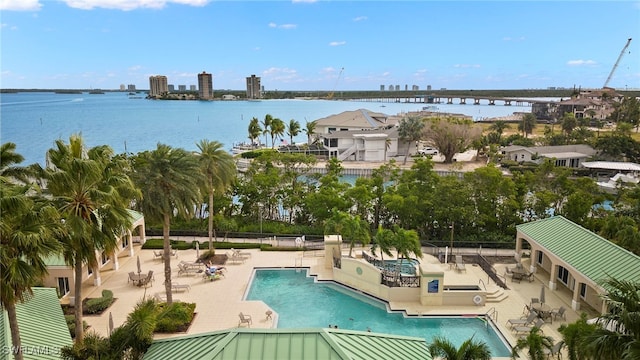 view of swimming pool with a patio and a water view