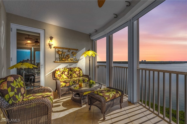 sunroom featuring a water view