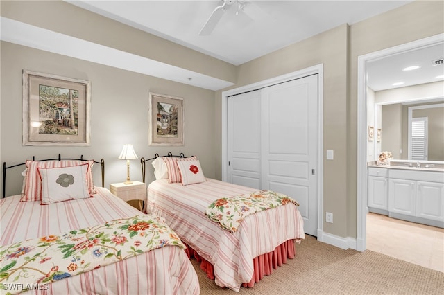 carpeted bedroom with sink, ceiling fan, and a closet