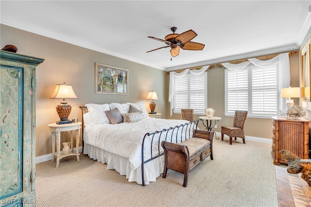 carpeted bedroom with crown molding and ceiling fan