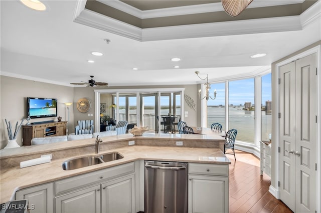 kitchen featuring decorative light fixtures, sink, dark hardwood / wood-style flooring, ornamental molding, and stainless steel dishwasher