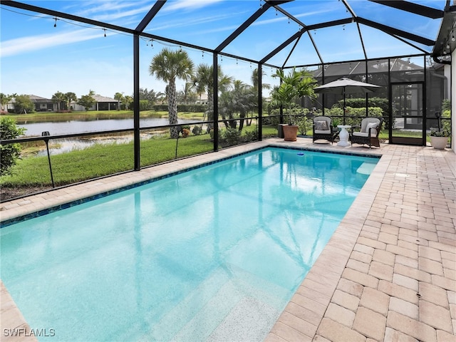 view of pool featuring a water view, glass enclosure, a lawn, and a patio area