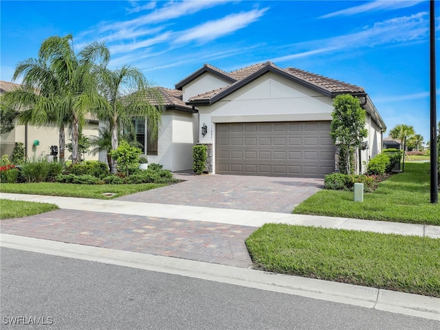 view of front facade featuring a garage and a front lawn