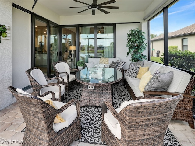 sunroom / solarium featuring ceiling fan and a wealth of natural light