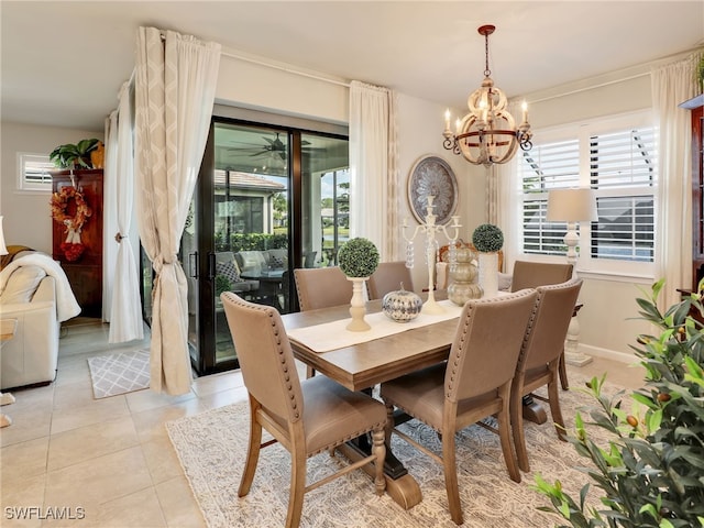 dining area featuring light tile patterned flooring and a chandelier