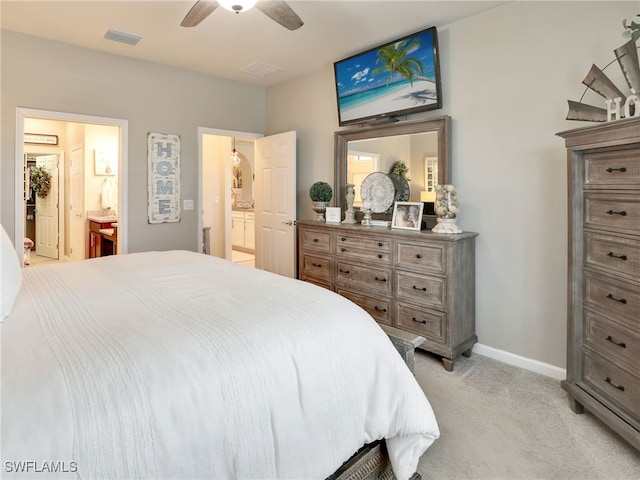 carpeted bedroom featuring ceiling fan and ensuite bath