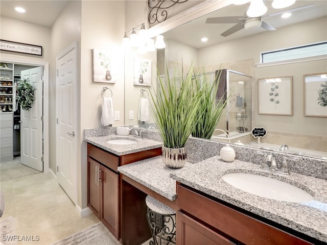 bathroom with tile patterned floors, ceiling fan, vanity, and a shower with shower door