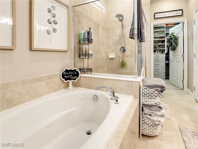 bathroom featuring tile patterned floors and independent shower and bath