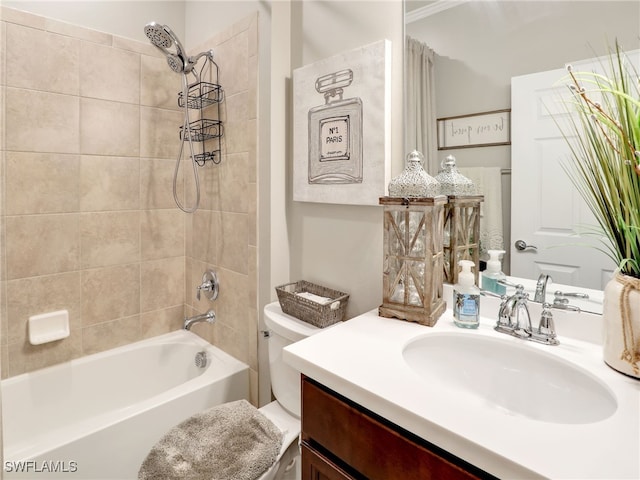 full bathroom featuring tiled shower / bath, vanity, and toilet