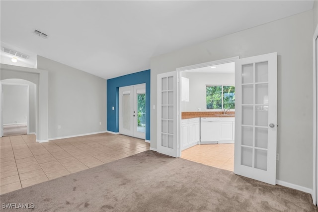 carpeted spare room featuring sink and french doors