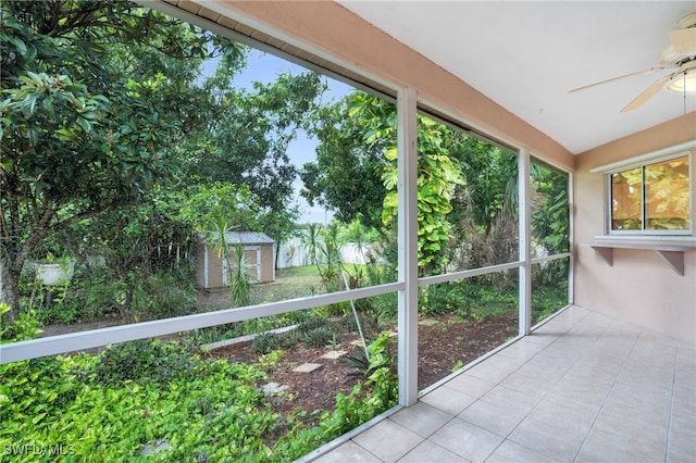 unfurnished sunroom featuring ceiling fan