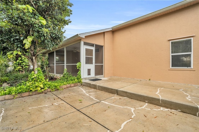 rear view of property with a patio area and a sunroom