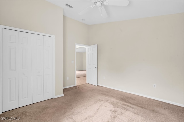 unfurnished bedroom featuring a closet, ceiling fan, and carpet floors