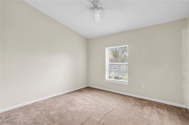 unfurnished room with lofted ceiling, ceiling fan, and light carpet