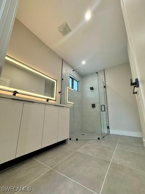 bathroom with an enclosed shower, concrete floors, and vanity