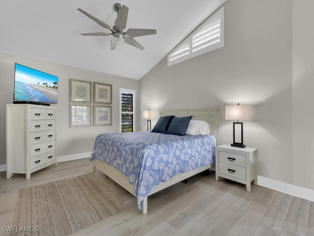 bedroom with ceiling fan, light hardwood / wood-style floors, and lofted ceiling