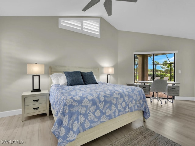 bedroom with ceiling fan, light hardwood / wood-style floors, and lofted ceiling