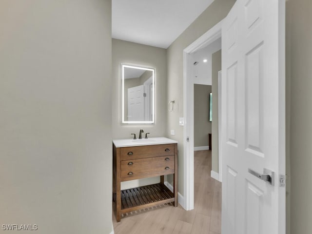 bathroom with hardwood / wood-style floors and vanity