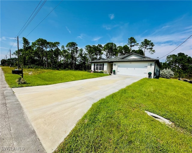 ranch-style house featuring a garage, concrete driveway, and a front yard