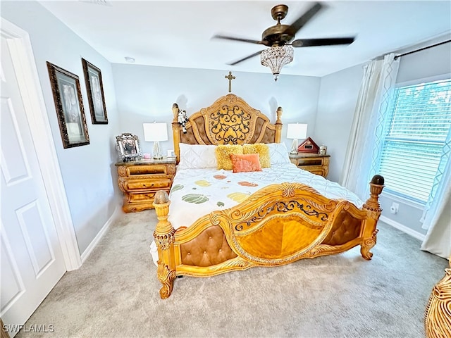 bedroom featuring light carpet, ceiling fan, and baseboards