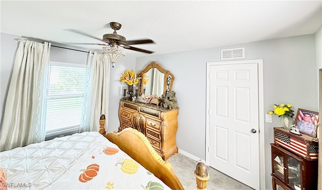 carpeted bedroom featuring visible vents and a ceiling fan