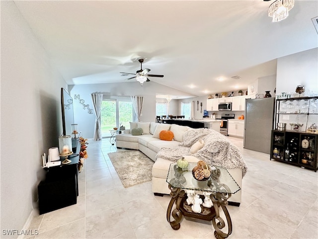 living room with lofted ceiling, light tile patterned floors, and a ceiling fan