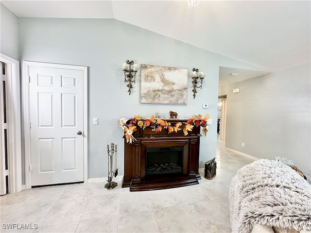 living area with vaulted ceiling and baseboards