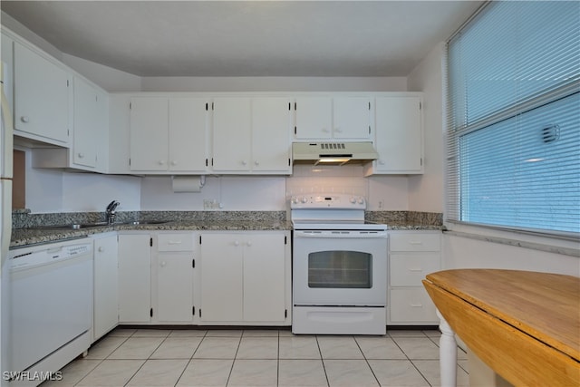 kitchen featuring light tile patterned flooring, white appliances, and white cabinetry