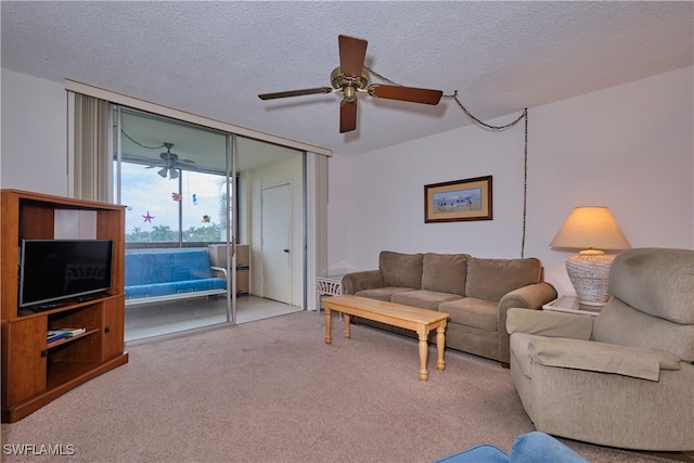 living room with ceiling fan, light colored carpet, and a textured ceiling